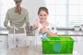 Little girl holding recycling bottles with thumbs up Royalty Free Stock Photo