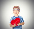 Little girl holding a red heart toy. Royalty Free Stock Photo