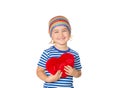 Little girl holding a red heart toy. Royalty Free Stock Photo