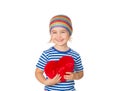 Little girl holding a red heart toy. Royalty Free Stock Photo