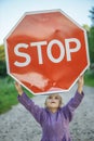 Little girl holding a red sign Royalty Free Stock Photo