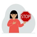 Little girl holding a red stop sign in her hand. Royalty Free Stock Photo