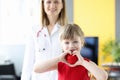 Little girl holding red toy heart in her hands in doctors office Royalty Free Stock Photo