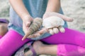 a little girl holding sea shells in her hands Royalty Free Stock Photo