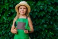Little girl holding shovel and sprout in a soil Royalty Free Stock Photo