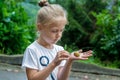 Little girl holding snail in hand