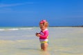 Little girl holding starfish at summer beach Royalty Free Stock Photo