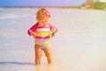 Little girl holding starfish at summer beach Royalty Free Stock Photo