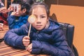 Girl holding sticks of Sendai Famous Fish Tofu and taking selfie