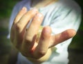 Little girl holding a stone in her hand. The stone is a close-up. The girl does not focus