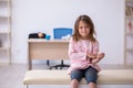 Small girl holding syringe waiting for doctor in the clinic Royalty Free Stock Photo