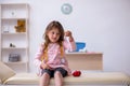 Small girl holding syringe waiting for doctor in the clinic Royalty Free Stock Photo