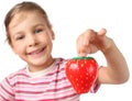 Little girl holding timer in shape of strawberries