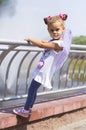 Little girl holding on to the railing