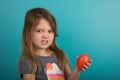 Little girl holding tomato