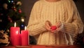 Little girl holding toy heart in arms, Christmas magic time kindness, charity