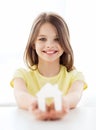 Little girl holding white paper house Royalty Free Stock Photo