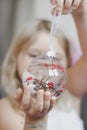 Little girl holds Beautiful Christmas ornament Royalty Free Stock Photo