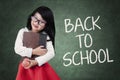 Little girl holds book back to school Royalty Free Stock Photo