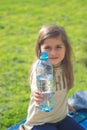 Little girl holds bottle of water