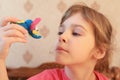 Little girl holds elephant and looks at him Royalty Free Stock Photo