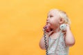 A little girl holds in her hands a tube from a wired telephone and looks around Royalty Free Stock Photo