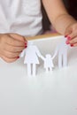 Little girl holds paper chain family; happy or broken family co Royalty Free Stock Photo