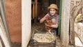 a little girl holds and strokes a red hen near a nest of eggs. laying hen.