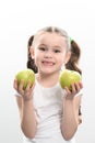 a little girl holds two green apples in her hands on a white background Royalty Free Stock Photo