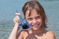 Little girl holds up a sea urchin she found in the sea Royalty Free Stock Photo