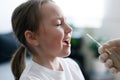 Little girl at home crying during taking nasal mucus test showing Covid-19 virus Royalty Free Stock Photo