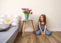 Little girl at home sitting near bed playing Royalty Free Stock Photo