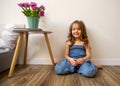 Little girl at home sitting near bed playing Royalty Free Stock Photo