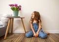 Little girl at home sitting near bed playing Royalty Free Stock Photo