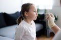 Little girl at home during taking nasal mucus test showing Covid-19 virus Royalty Free Stock Photo