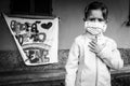 Little girl with homemade face protective mask. Blurred background with the famed rainbow drawing and the message