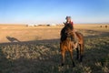 A little girl on a horse in Mongolian steppe