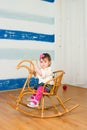 Little girl on a horse rocking chair Royalty Free Stock Photo