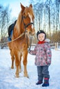 Little girl on a horse in winter, horseback riding Royalty Free Stock Photo