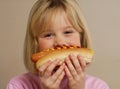 Little girl with hot dog smiling Royalty Free Stock Photo