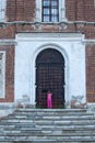 Little girl at the huge metal doors to temple Royalty Free Stock Photo