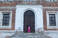 Little girl at the huge metal doors to temple Royalty Free Stock Photo