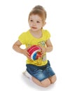Little girl hugging the ball. Royalty Free Stock Photo