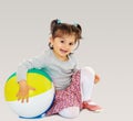 Little girl hugging a big ball Royalty Free Stock Photo