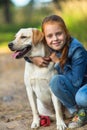 Little girl hugging a dog during a walk. Love. Royalty Free Stock Photo