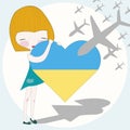 Little girl hugging heart in Ukrainian flag colors on the background in the sky war air planes attacking