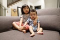 Adorable asian siblings being playful at their home stock photo