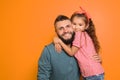 Little girl hugging her father on color background Royalty Free Stock Photo