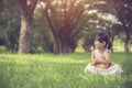 little girl hugging her teddy bear in park. Royalty Free Stock Photo