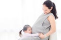 Little girl hugging and listening sound from her pregnant mother`s belly Royalty Free Stock Photo